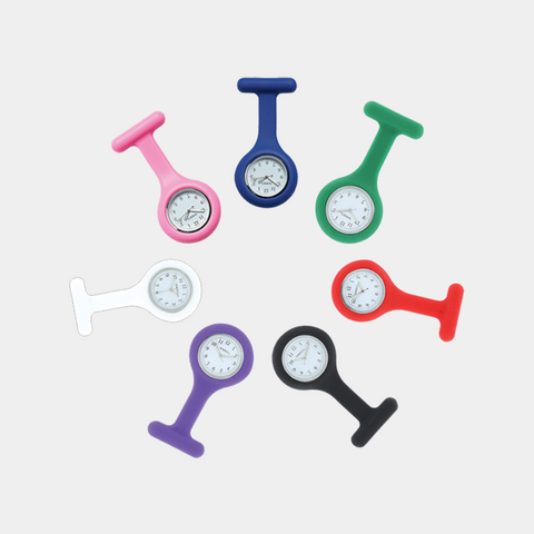 A collection of silicone fob watches in various colors, each featuring a large white 24-hour dial. Designed for healthcare professionals, these watches offer a secure pin clasp closure and a hygienic, easy-to-clean silicone casing.